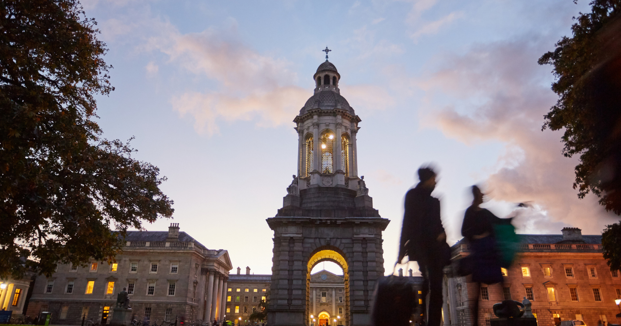 A shot of a college campus entry gate at twilight. 