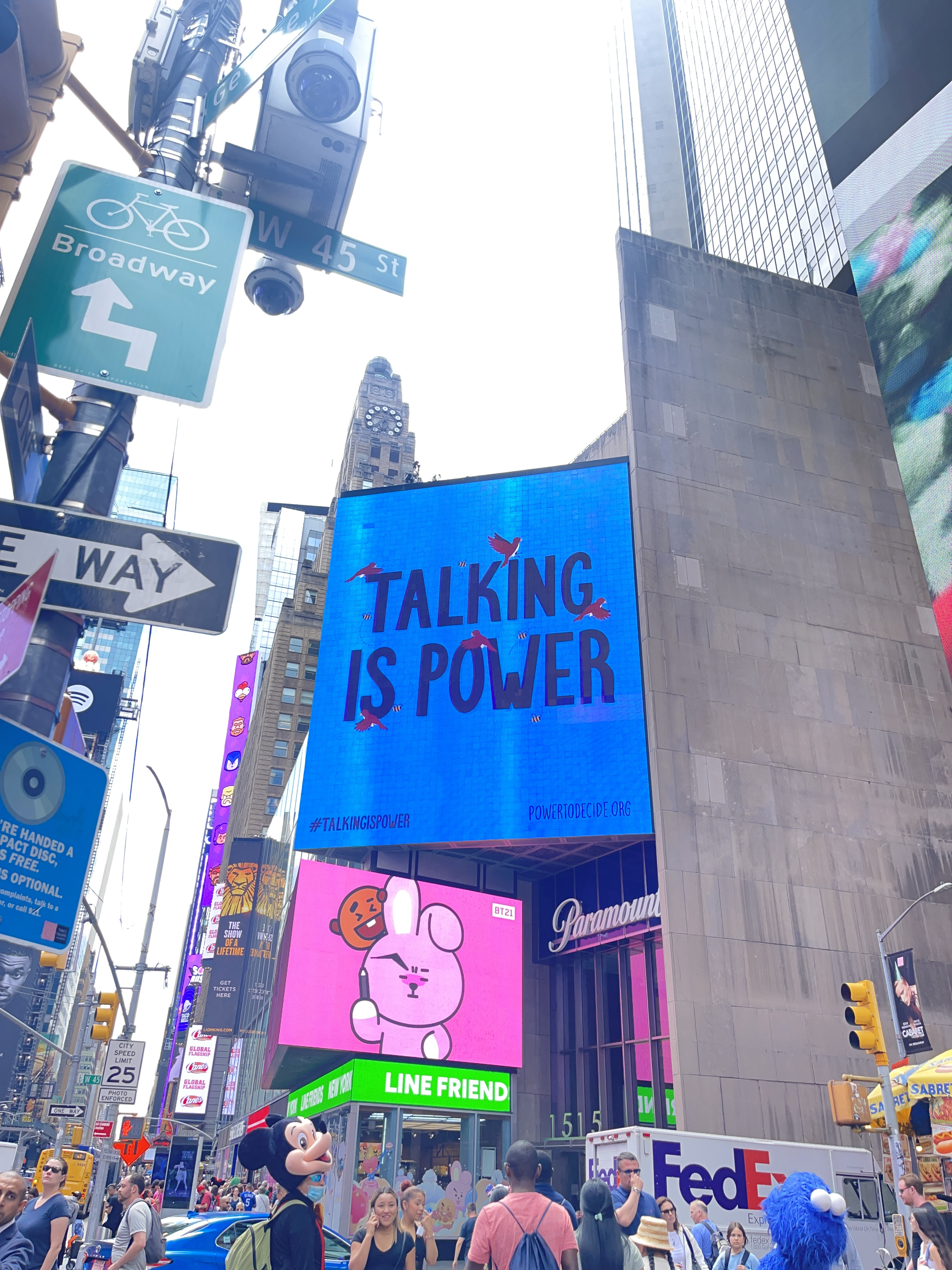 A photo of a Times Square NYC billboard that reads, "Talking is Power."