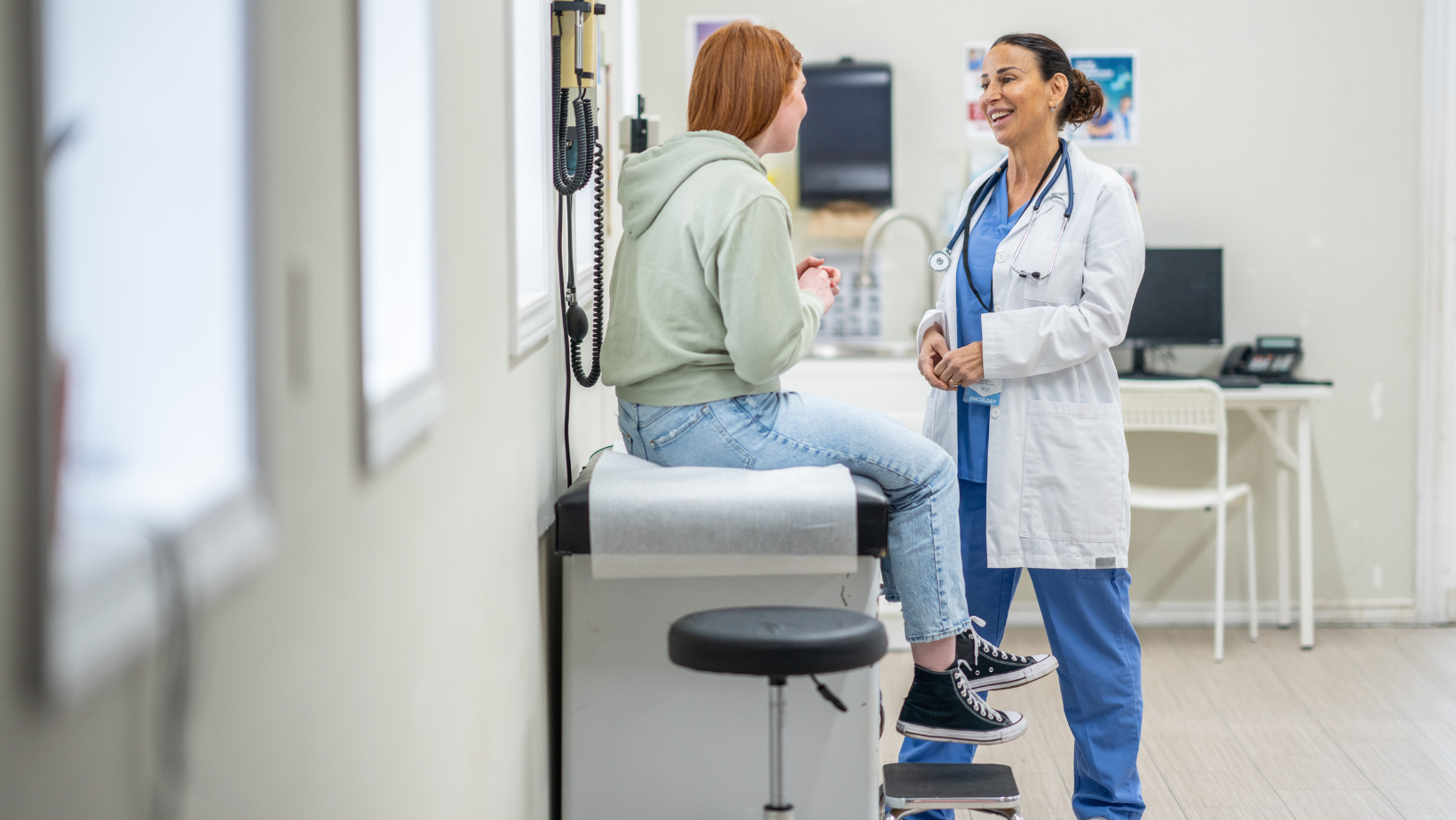 Adolescent sitting at a doctor's office talking about birth control.