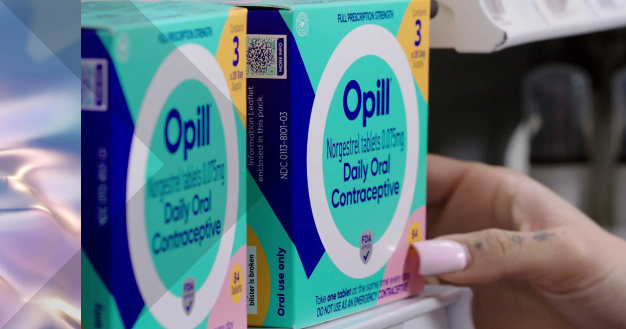 An image of a hand pulling a box of Opill off the shelf at a store. 