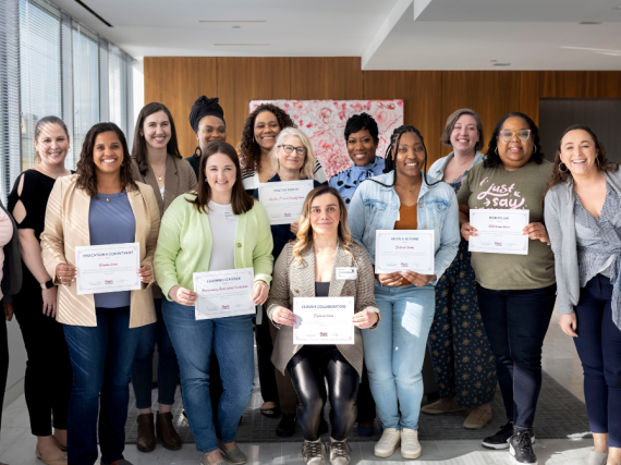 Our first round of shared learning collaborative teams pose for a group photo at an in person meeting. 