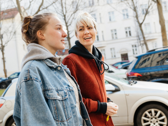 A mother and her teen daughter go for a walk. 