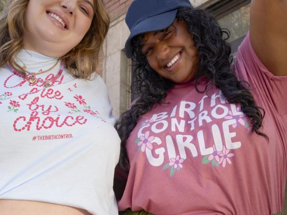 Two people each wearing a thanks, birth control shirt 
